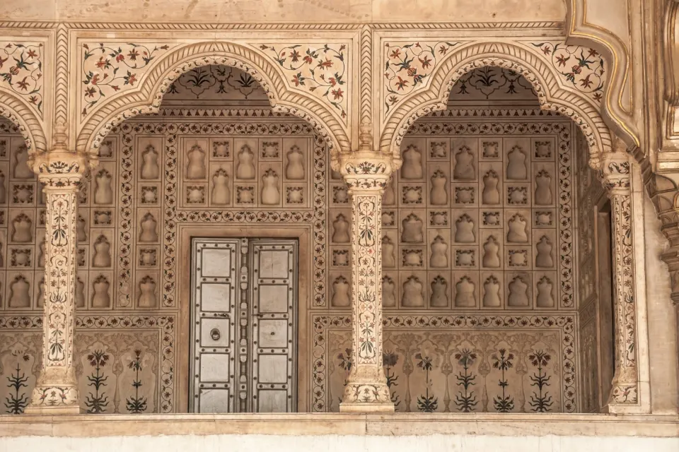 Interior marble arches inside the Taj Mahal decorated with floral pietra dura inlay