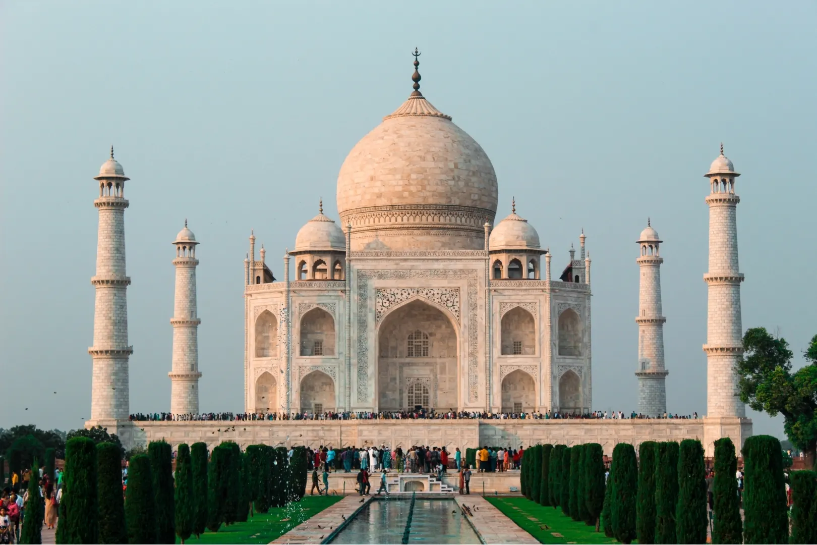 Wide view of the Taj Mahal complex with minarets and the long reflecting pool in front