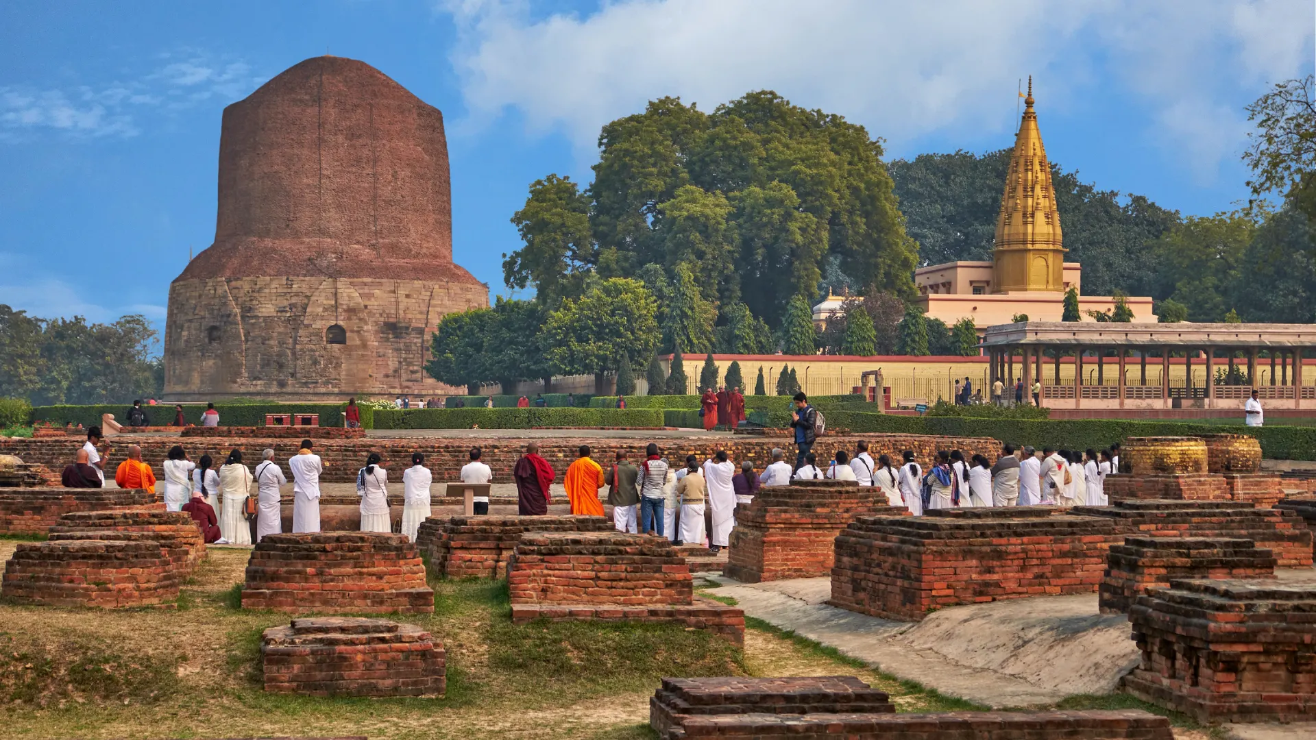 Buddhist pilgrims gathered near the Dhamek Stupa at Sarnath