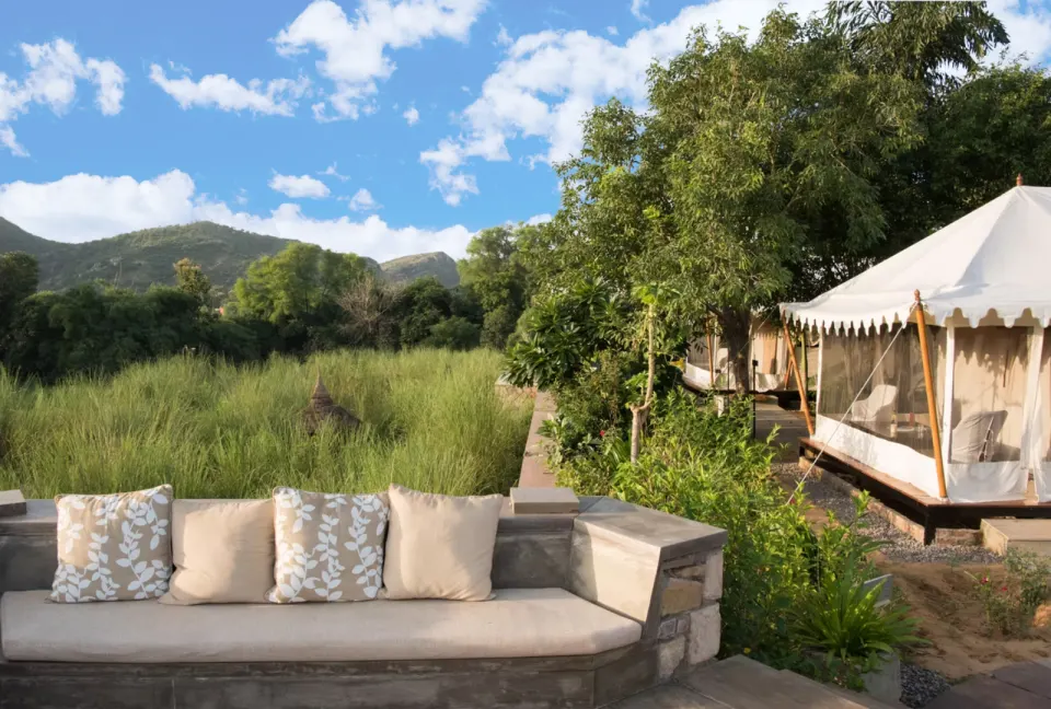 Outdoor lounge seating overlooking tall grass meadow at Khem Villas