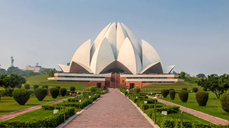 Lotus Temple viewed from central walkway with landscaped gardens