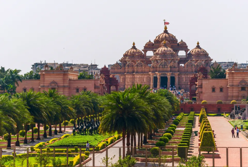 Swaminarayan Akshardham temple complex with gardens and palm-lined paths