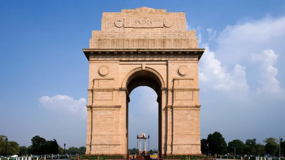 India Gate war memorial arch standing against a blue sky in New Delhi