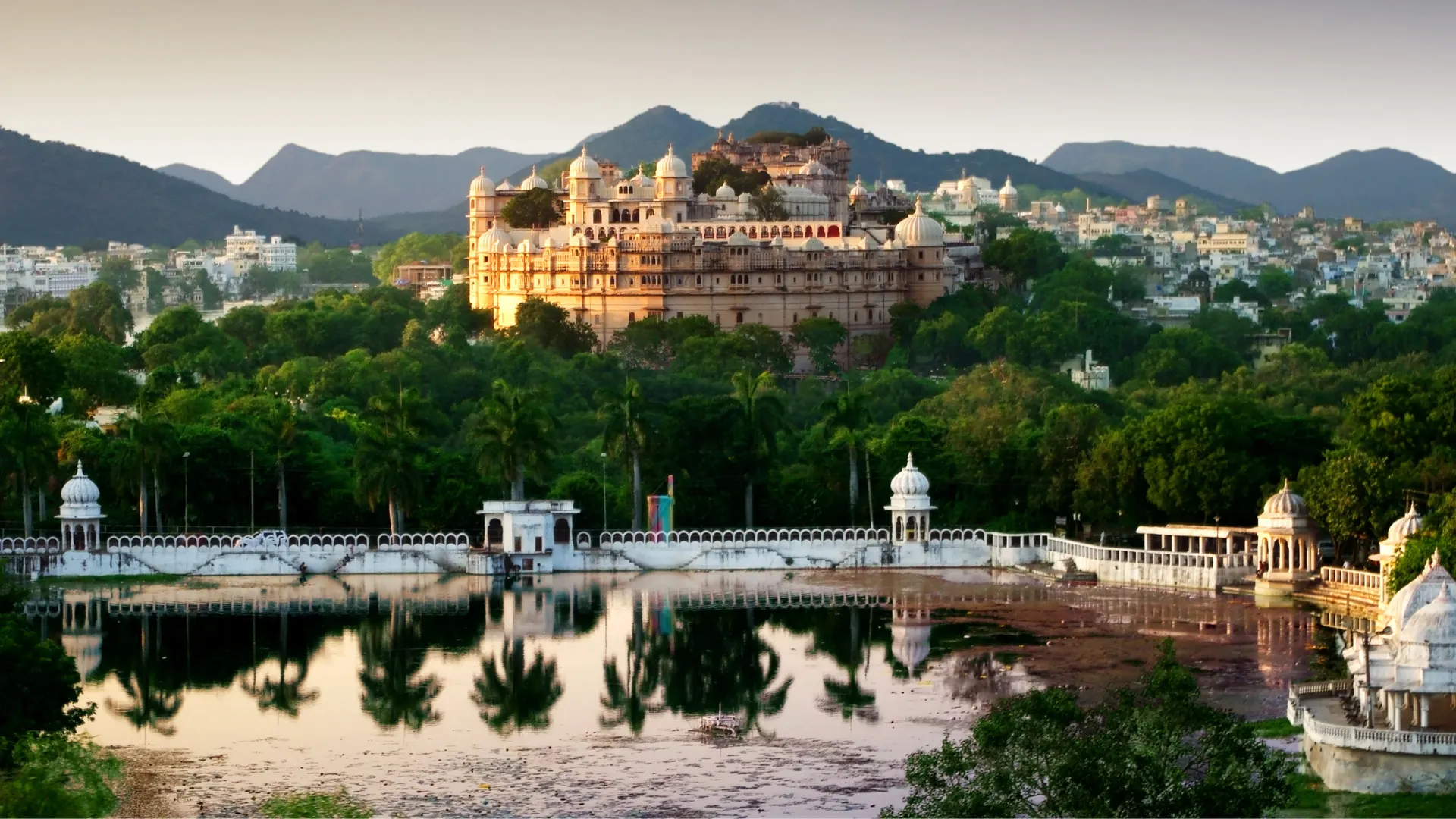 Umaid Bhawan Palace seen across gardens and water reflection
