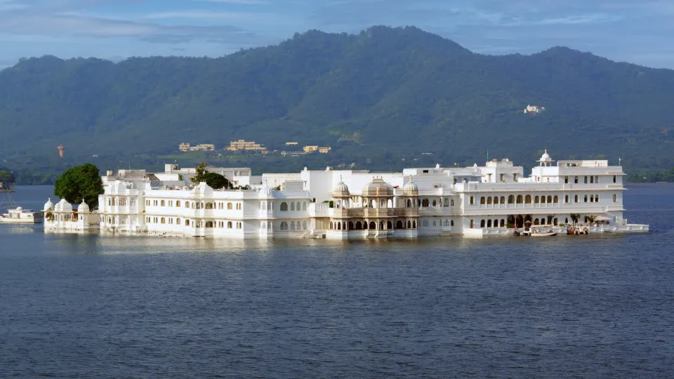 Lake Palace floating on Lake Pichola with Aravalli Hills in background