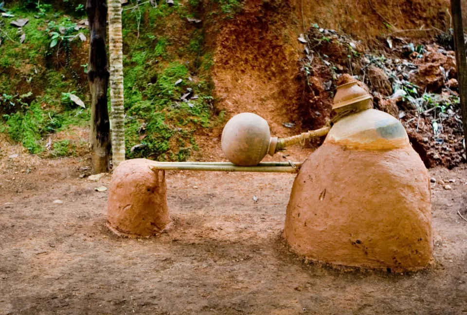 traditional cashew feni distillation setup made from clay pots and bamboo in goa