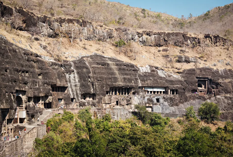 panoramic view of ellora caves carved into basalt cliff