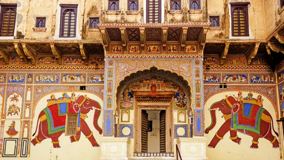 arched haveli gateway with large elephant murals in mandawa