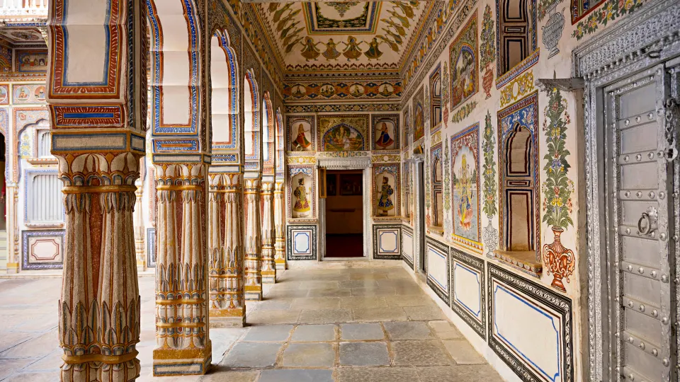 Columned veranda with fresco-painted walls inside a Mandawa haveli