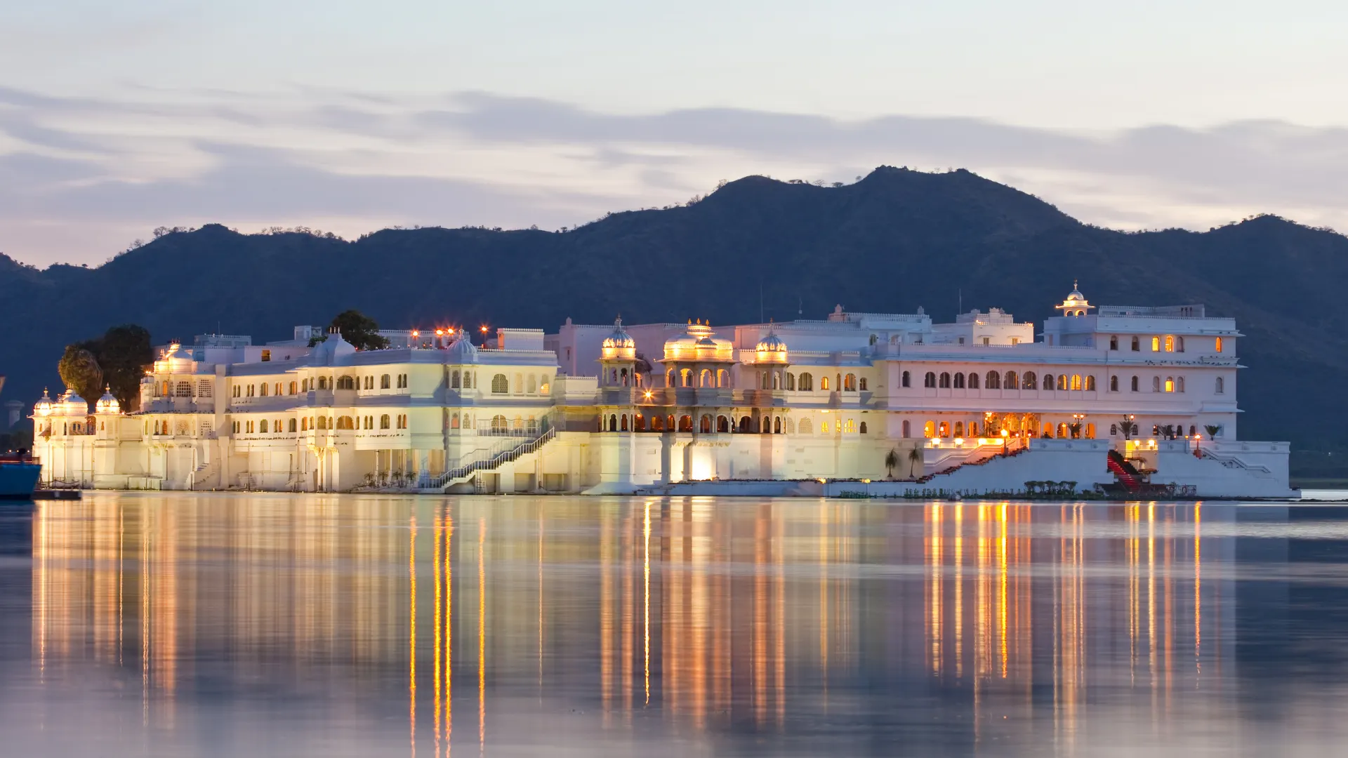 Taj Lake Palace illuminated at dusk on Lake Pichola in Udaipur