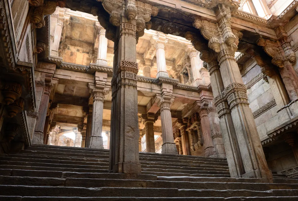 Stone staircase and carved pillars inside Adalaj Stepwell