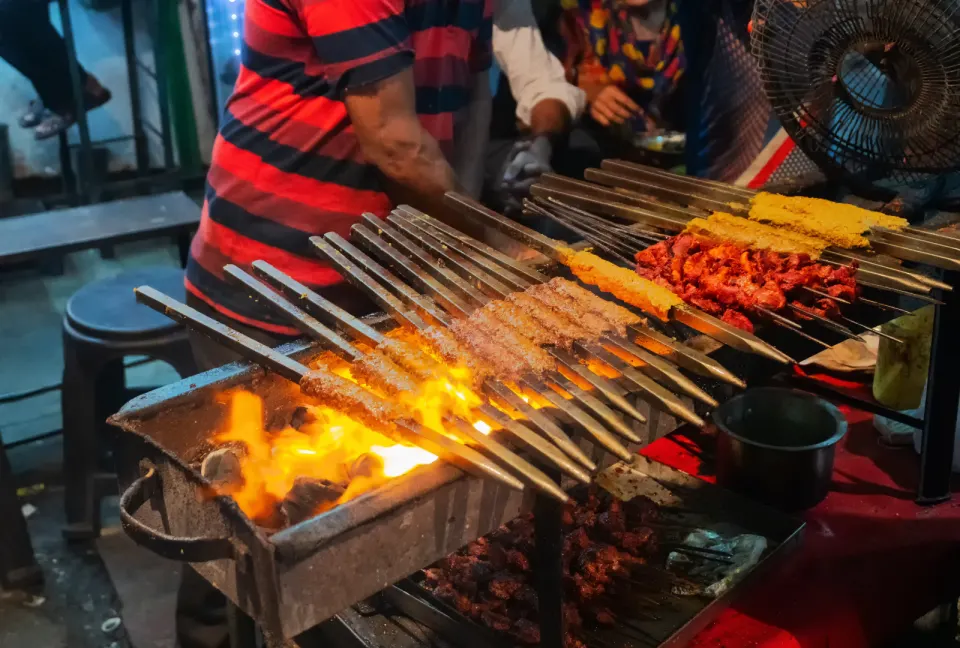 assorted kebabs grilling at night stall