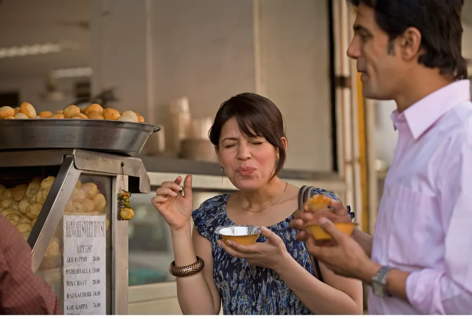 people eating pani puri at street stall