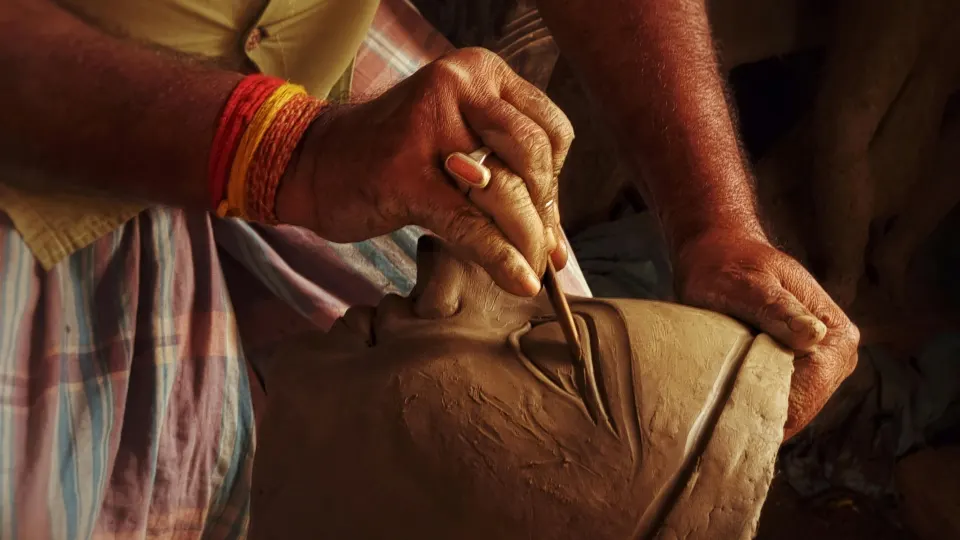 artisan sculpting clay idol in kolkata