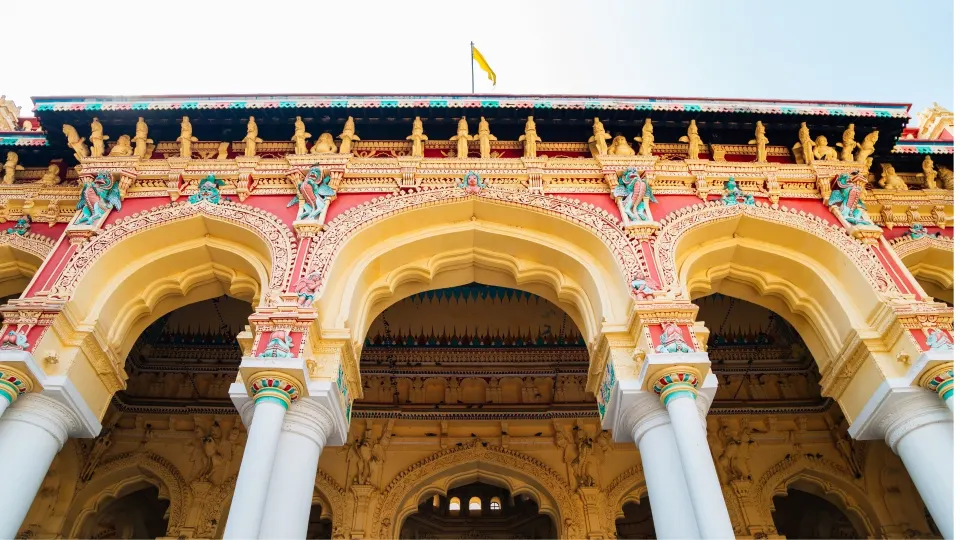 arched courtyard facade of a chettinad palace with ornate stucco work