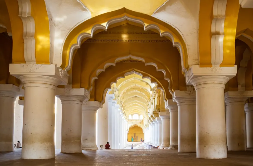 pillared corridor with scalloped arches inside a chettinad palace