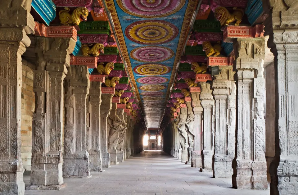 Stone-pillared hall with vividly painted ceiling inside Madurai Meenakshi Temple