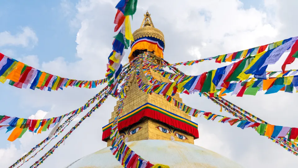 Colorful prayer flags stretching outward from the Boudhanath Stupa in Nepal