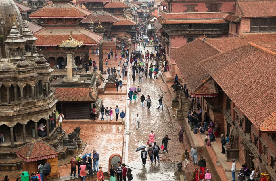 Aerial view of Bhaktapur Durbar Square with temples, people, and red brick pathways