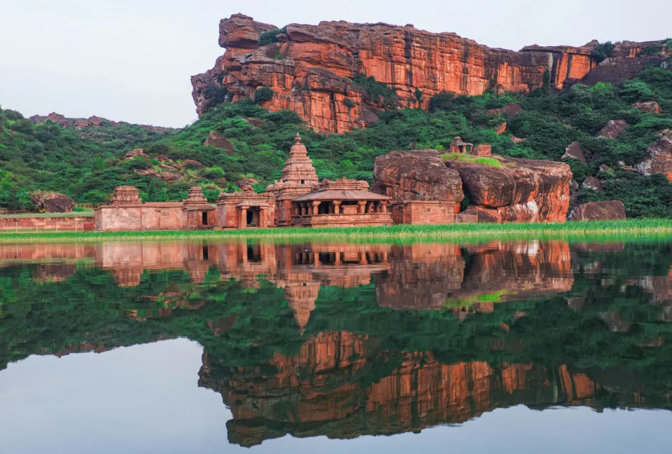 Ancient sandstone temples reflected in Agastya Lake, Badami