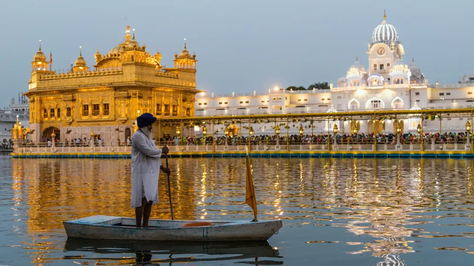 Daytime portrait view of the Golden Temple with reflection