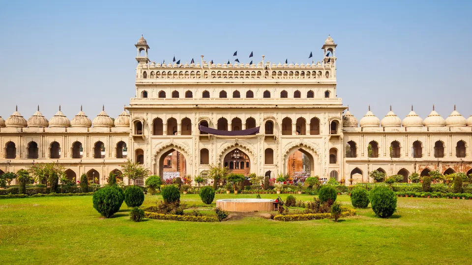 Front view of Bara Imambara in Lucknow with arched façade and domed pavilions framed by manicured lawns