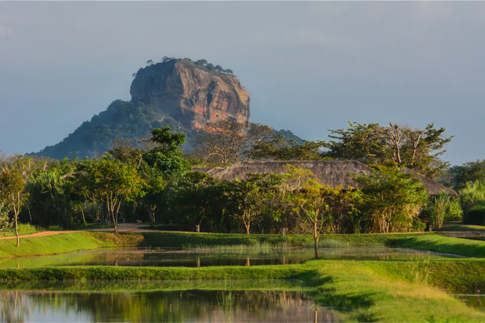 Sigiriya Rock rising above gardens and water in Sri Lanka