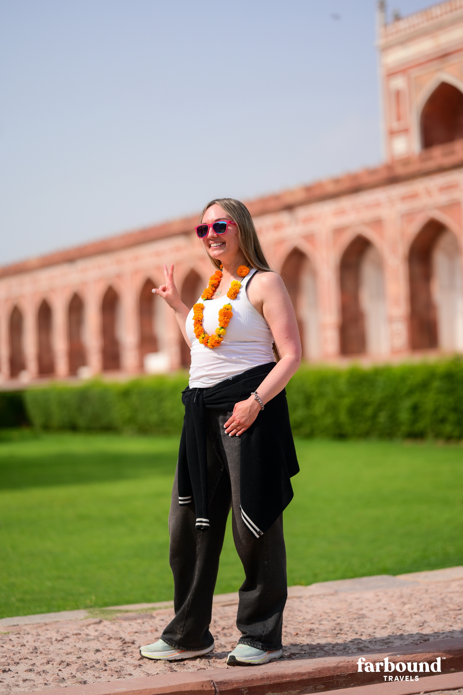 Farbound traveller wearing a marigold garland at Humayun’s Tomb in Delhi.